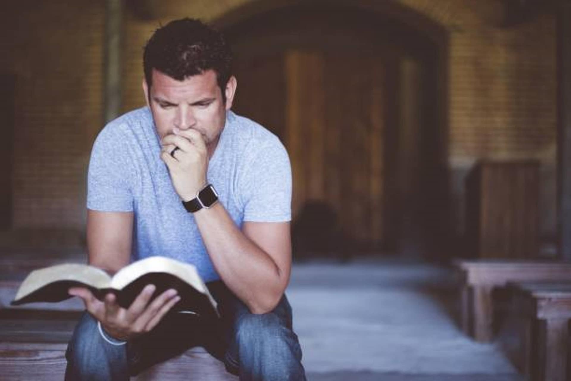 A picture of a student studying the Bible.