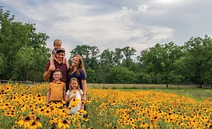 the Jones family standing in a field of flowers