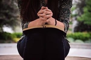 girl praying with bible web 1000