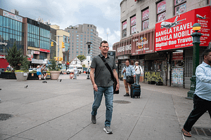 Kevin King walking through Diversity Plaza in NYC