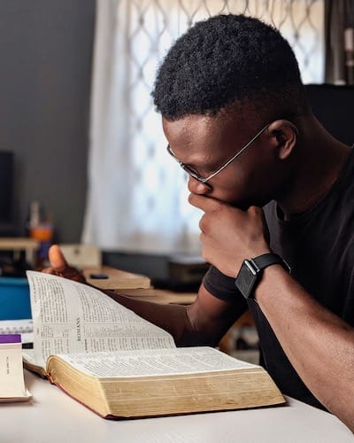 An image of a student studying the bible.