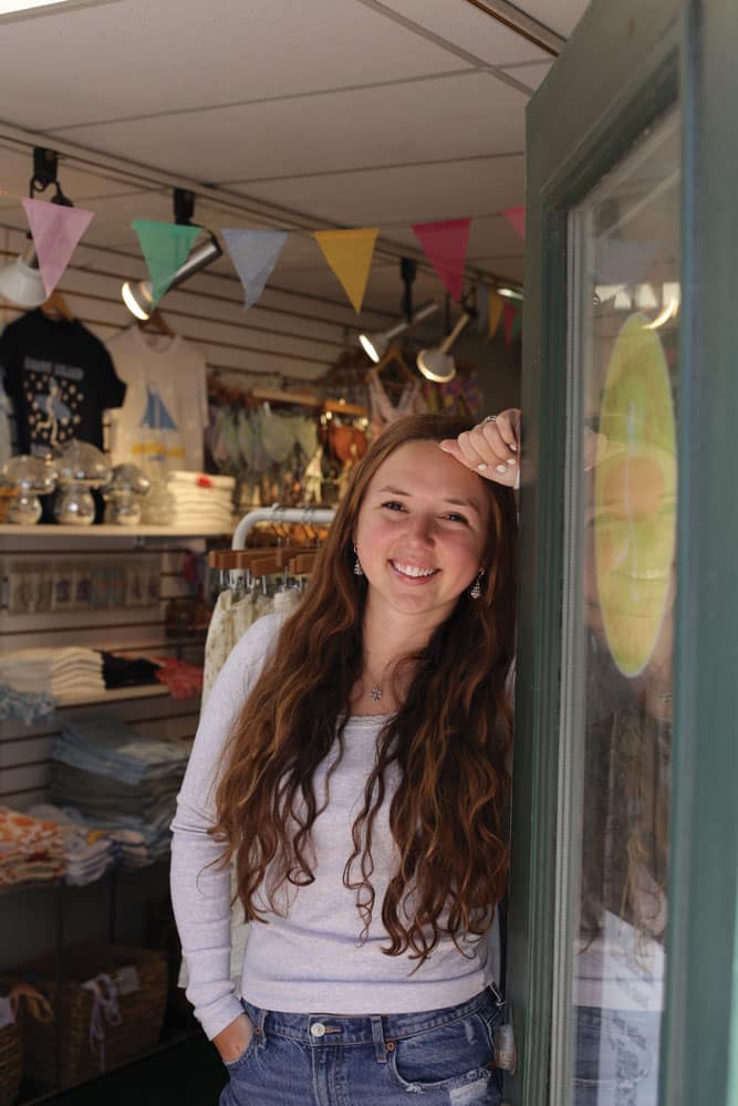 Abigail Edman poses for a photo in the doorway of The Sundance Company's retail space in Newport, RI.