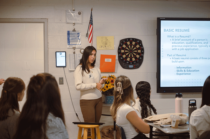 image of Cairn student standing next to a Smart Board and giving a presentation